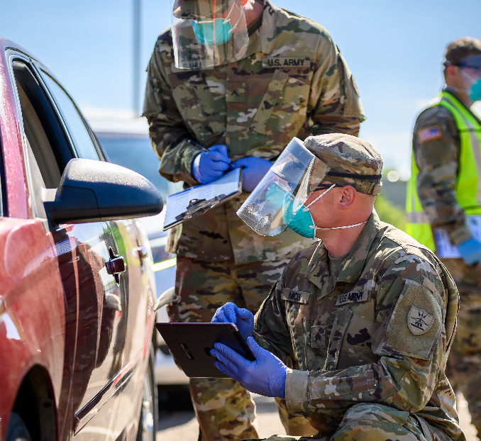 Sgt. Ethan Micek, right, 957th Engineer Company, and Pvt. Jerome Sahli, 1st Battalion 188th Air Defense Artillery, work as data collectors at the COVID-19 mobile testing site at the N.D. State Capitol in Bismarck, N.D. on June 24, 2020. (U.S. Army National Guard photo by Sgt. 1st Class Brett Miller, 116th Public Affairs Detachment)