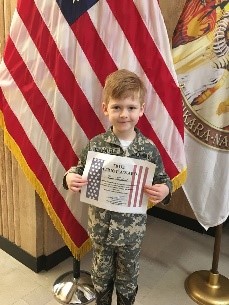 Child holding a certificate