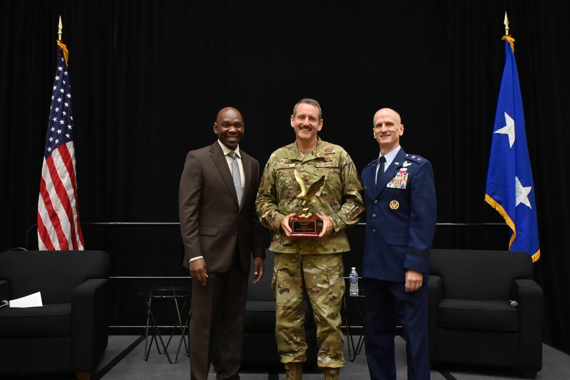 U.S. Air Force Col. Lee Teigen, commander, 119th Operations Group, 119th Wing, North Dakota Air National Guard, receives the William W. Spruance Safety Award from (left) retired Maj. Gen. Ondra Berry, NGAUS vice chair-Air, and (right) U.S. Air Force Maj. Gen. Randy Efferson, the acting director of the Air National Guard, at the 148th NGAUS General Conference & Exhibition, Indianapolis, Indiana, August 31, 2026.   