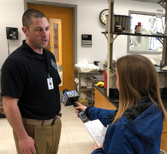 Maj. Aaron Norgaard, medical operations officer for the 81st CST and National Guard liaison to the N.D. Department of Health (NDDoH) is interviewed by KX News reporter Renee Cooper on April 3, 2020 at the NDDoH lab in Bismarck. (National Guard photo by Bill Prokopyk, N.D. Public Affairs Office)