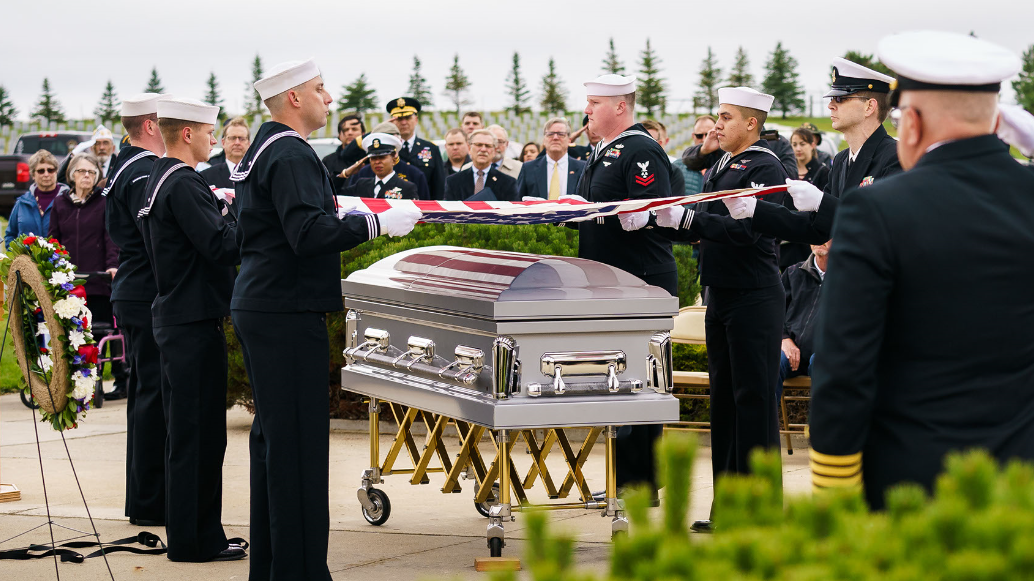 Navy Funeral Honors prepare to fold the U.S. Flag draped over the casket of Radioman 2nd Class Floyd A. Wells at the N.D. Veterans Cemetery on Oct. 1, 2019. Wells was killed on Dec. 7, 1941 when the Imperial Japanese Navy attacked the U.S. Navy fleet docked at Pearl Harbor, Hawaii.
