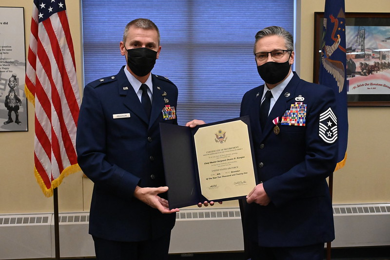 Brig. Gen. Darrin Anderson, right, presents the certificate of retirement to Chief Master Sgt. Duane Kangas