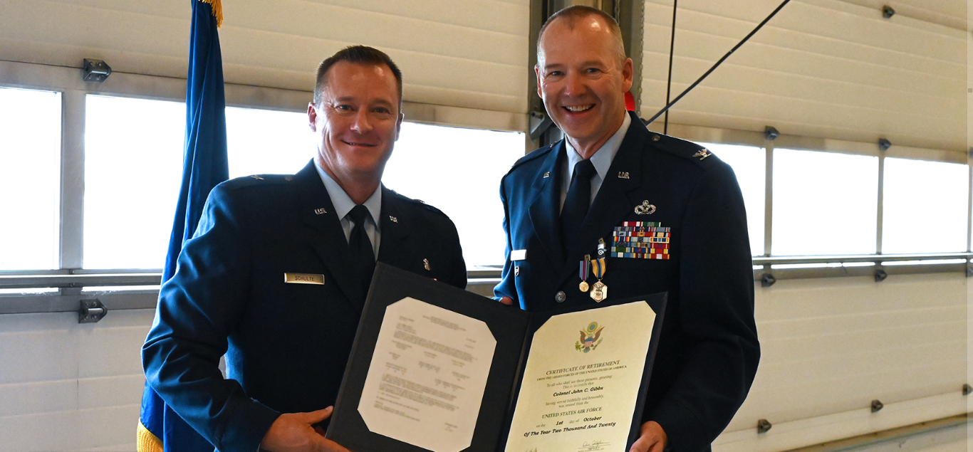 Brig. Gen. Bob Schulte, left, North Dakota National Guard chief of staff for Air, presents a certificate of retirement to Col. John Gibbs during his retirement ceremony on Sept. 12, 2020.