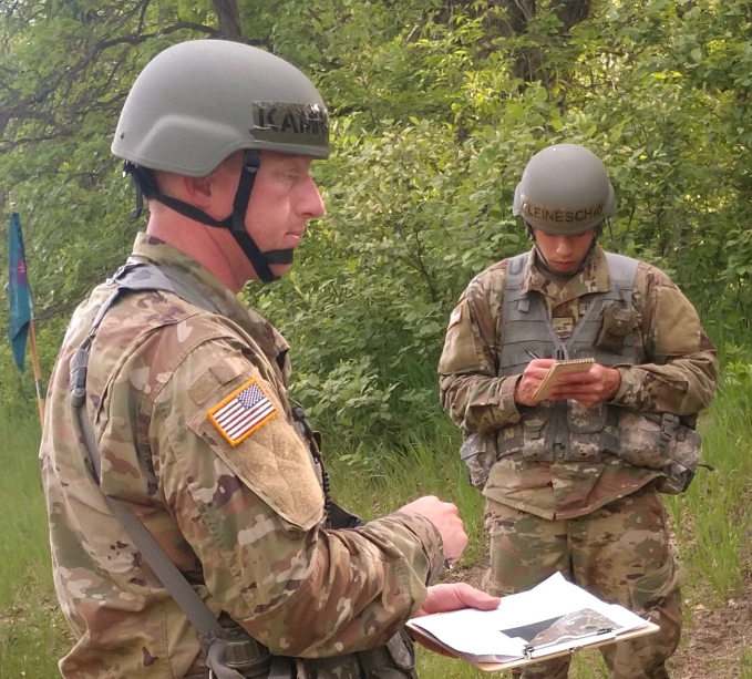 Members of Officer Candidate Class 64, OC Ryan Kamrowski, left, and OC Trevor Kleineschay, navigate the land navigation course on June 4, 2020 at the Camp Grafton Training Center.