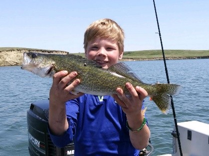 Child holding up a fish